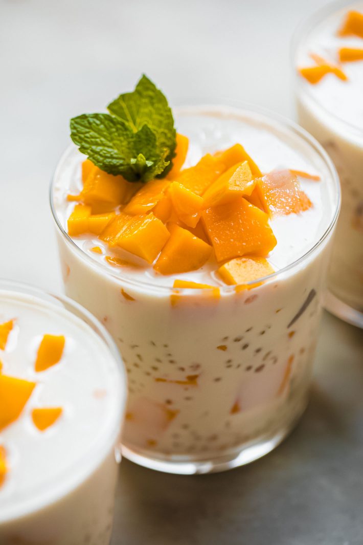 glass of pudding with mango chunks on top